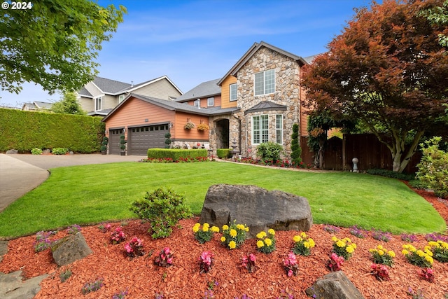 view of front of house with a garage and a front lawn