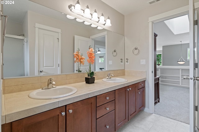 bathroom featuring vanity and a skylight