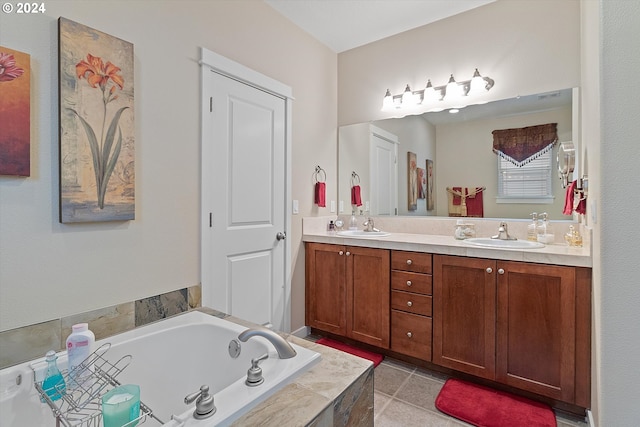 bathroom with vanity, tile patterned flooring, and tiled bath