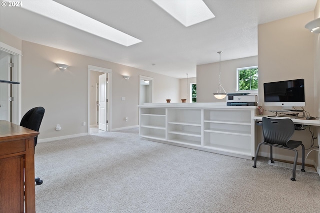 carpeted office featuring a skylight