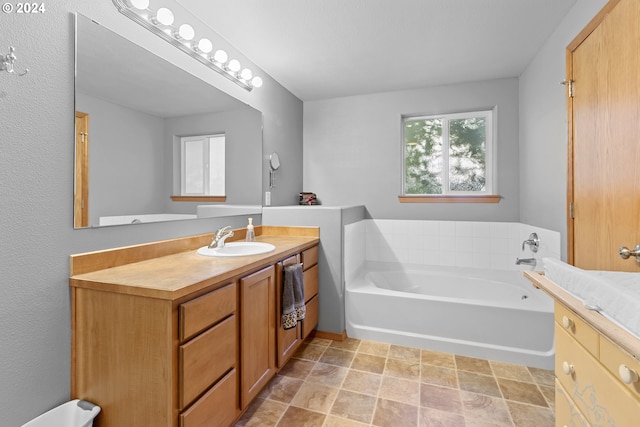 bathroom featuring vanity and a tub