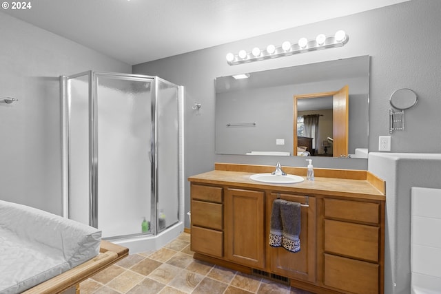 bathroom featuring vanity and an enclosed shower