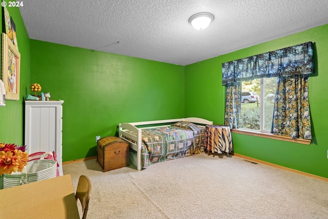 carpeted bedroom featuring a textured ceiling