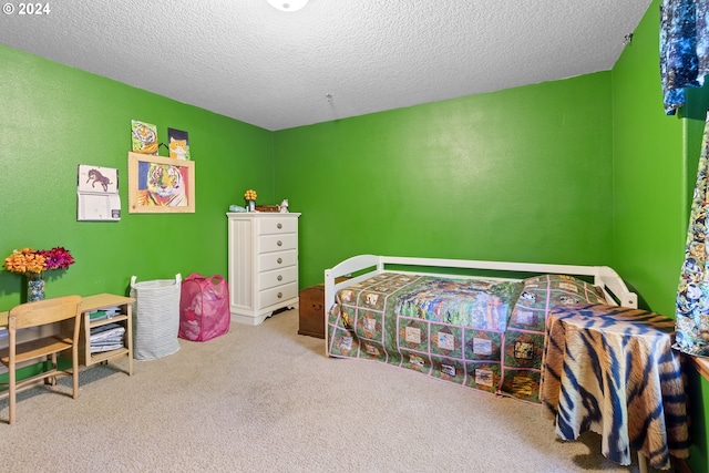 bedroom featuring light colored carpet and a textured ceiling