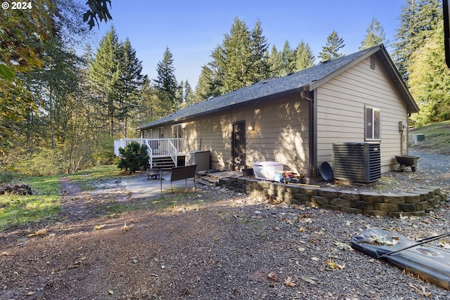 view of side of property featuring a patio area and a deck