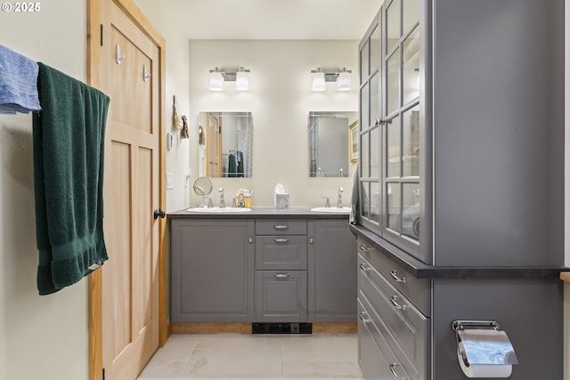 bathroom featuring double vanity, visible vents, tile patterned floors, and a sink