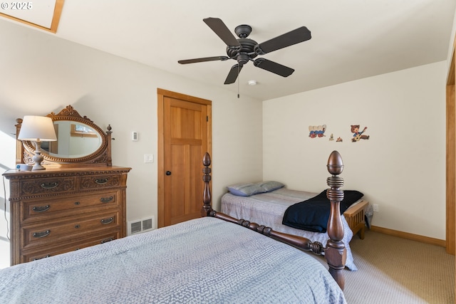 carpeted bedroom with a ceiling fan, baseboards, and visible vents