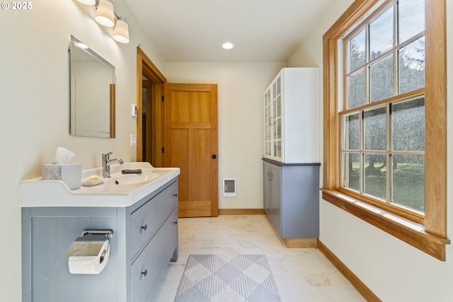 bathroom featuring visible vents, plenty of natural light, baseboards, and marble finish floor