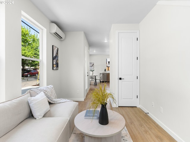 living room with light hardwood / wood-style flooring and a wall mounted AC