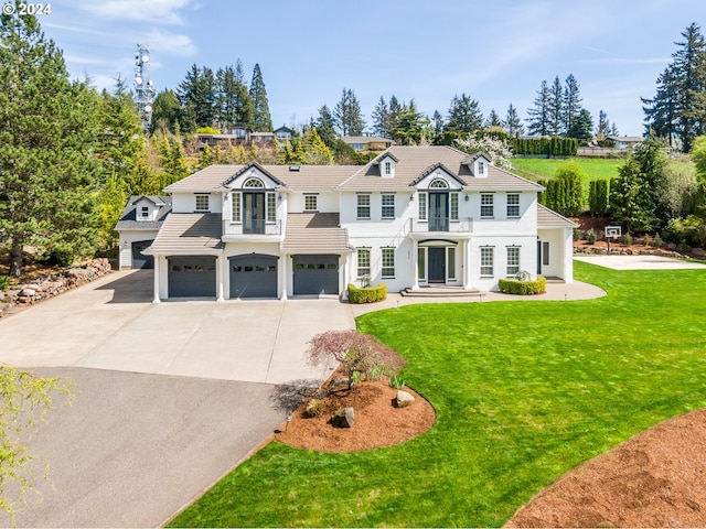 view of front of house with a garage and a front lawn