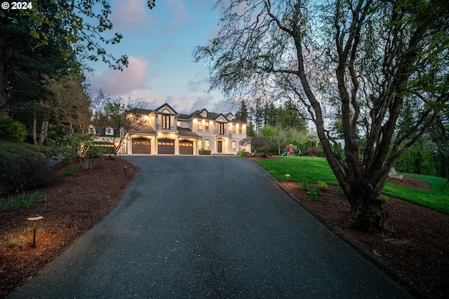 view of front of property featuring a yard and a garage