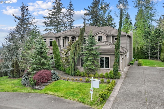 view of front of property with a front lawn and a garage