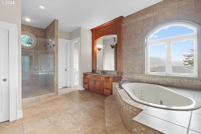 bathroom featuring tile walls, separate shower and tub, tile flooring, and vanity