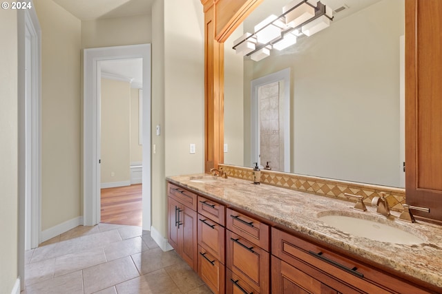 bathroom with crown molding, dual vanity, and tile flooring