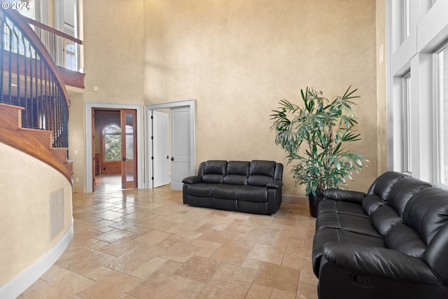 tiled living room with a high ceiling