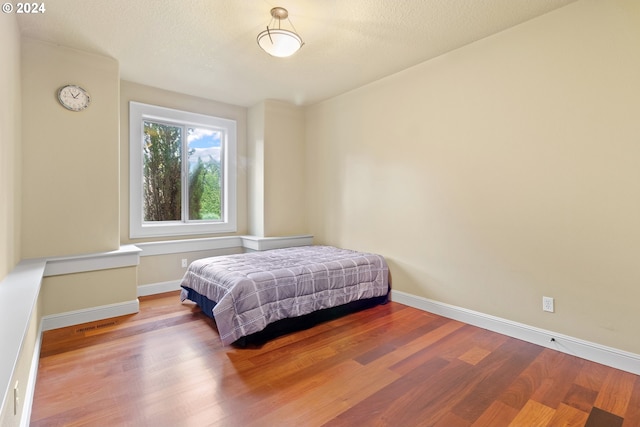 bedroom featuring wood-type flooring