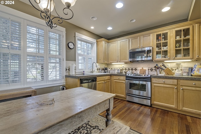 kitchen featuring dark hardwood / wood-style floors, appliances with stainless steel finishes, sink, an inviting chandelier, and light brown cabinets