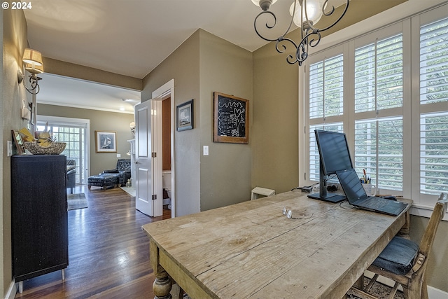 dining room with dark hardwood / wood-style floors and a chandelier