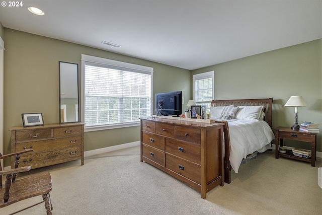 carpeted bedroom featuring multiple windows