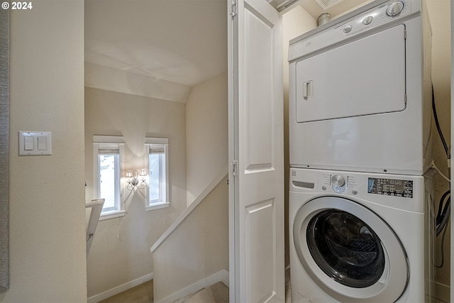 laundry area featuring stacked washer and clothes dryer