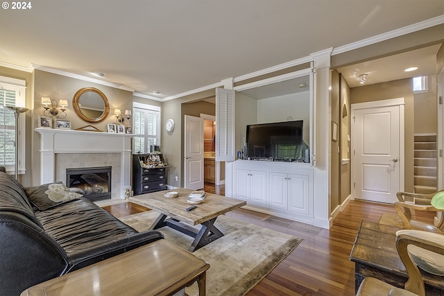 living room featuring a fireplace, ornamental molding, and hardwood / wood-style floors