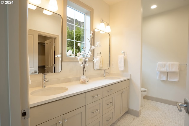 bathroom with tile patterned flooring, vanity, and toilet