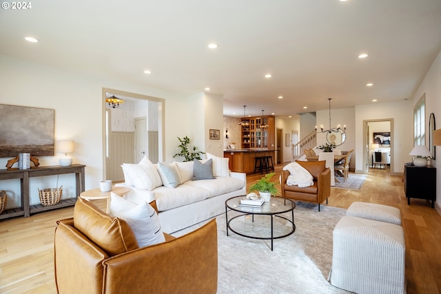 kitchen with an inviting chandelier, light wood-type flooring, decorative light fixtures, and tasteful backsplash