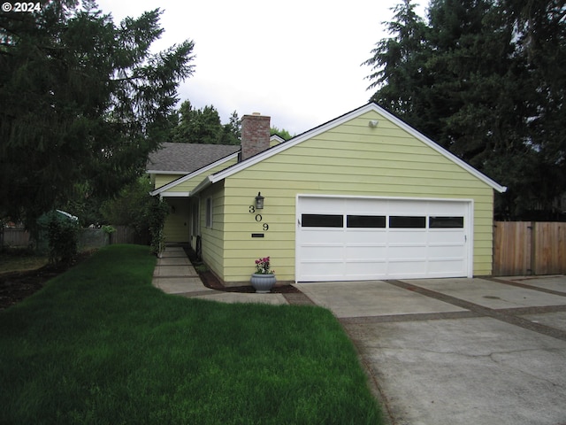 view of property exterior with a lawn and a garage