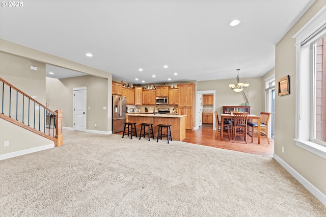 carpeted living room with sink and a notable chandelier