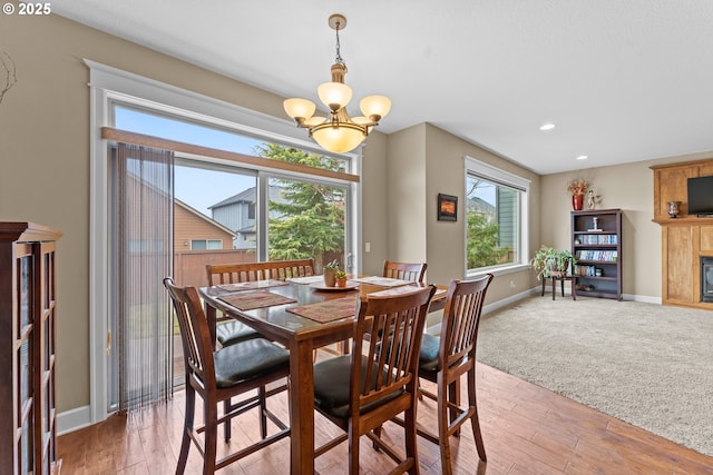 dining area with hardwood / wood-style flooring and a notable chandelier