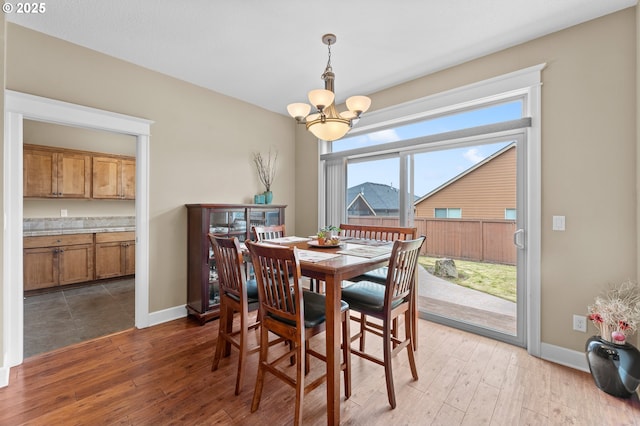 dining room with wood-type flooring and a chandelier