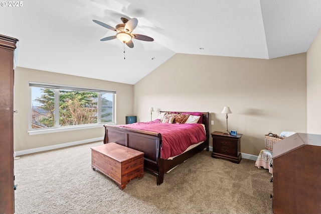 bedroom with vaulted ceiling, carpet flooring, a textured ceiling, and ceiling fan