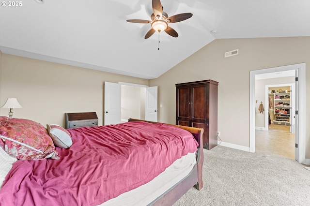 carpeted bedroom featuring ceiling fan and vaulted ceiling