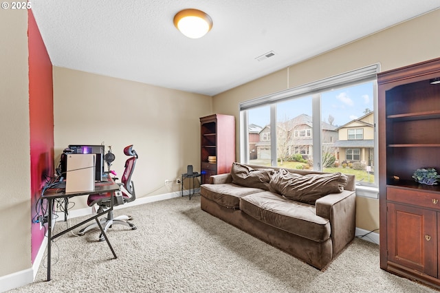 carpeted home office with a textured ceiling