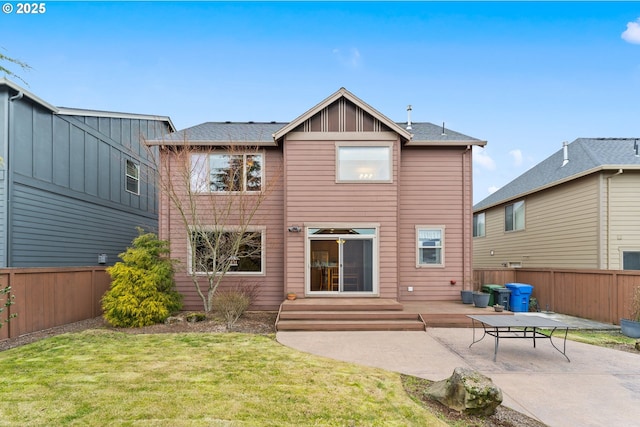 rear view of property with a patio and a yard