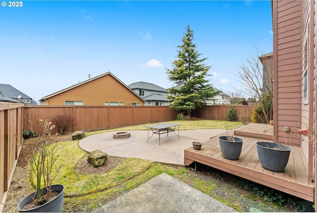 view of yard featuring an outdoor fire pit, a deck, and a patio area