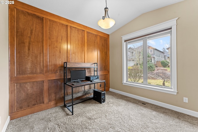 office area featuring light carpet and vaulted ceiling