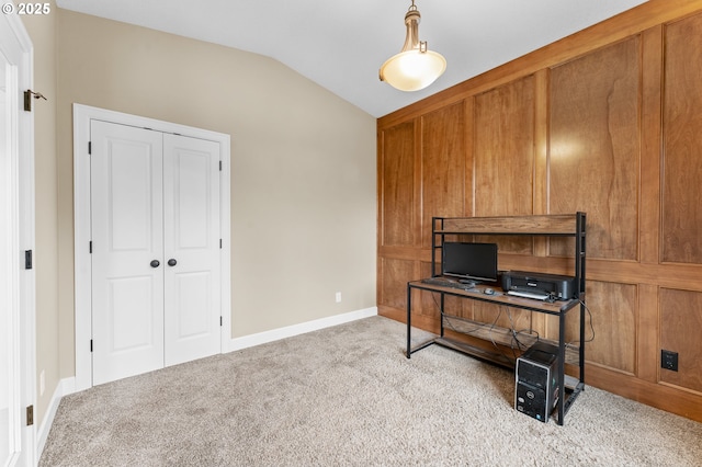 carpeted office featuring lofted ceiling