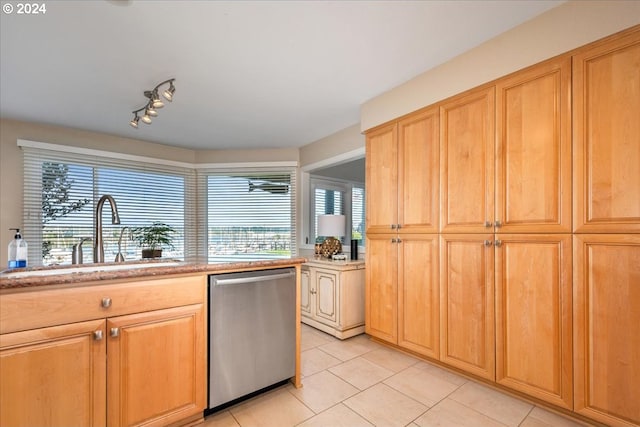 kitchen featuring sink, light tile patterned flooring, stainless steel dishwasher, and track lighting