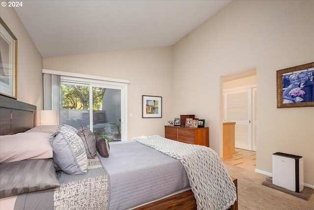 carpeted bedroom with access to outside and vaulted ceiling