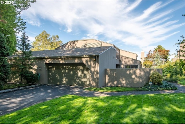 view of home's exterior featuring a lawn and a garage