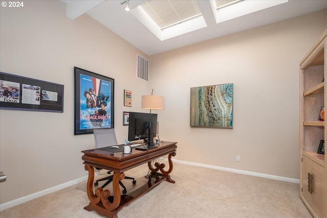 office space with light colored carpet and vaulted ceiling