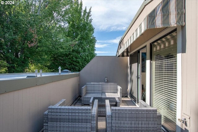 view of patio featuring outdoor lounge area and a balcony