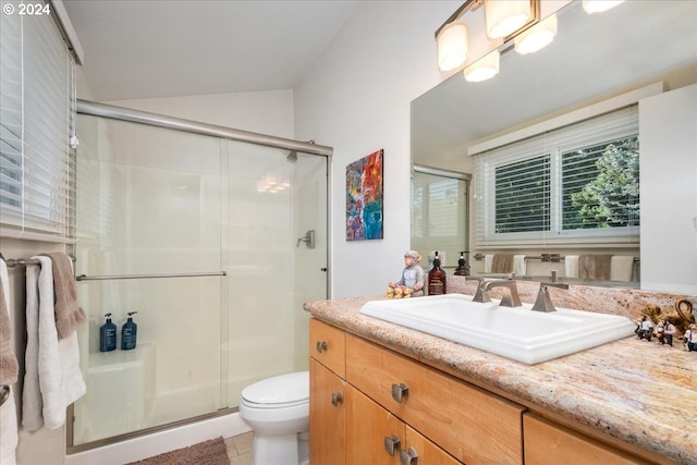 bathroom with tile patterned flooring, vanity, lofted ceiling, and walk in shower