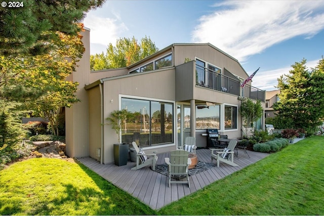 rear view of property featuring a lawn and a balcony