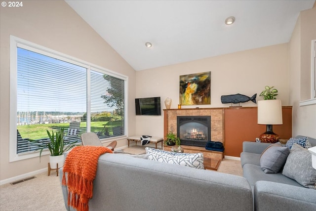 carpeted living room featuring a fireplace and vaulted ceiling