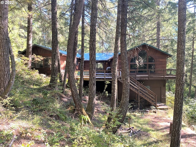 back of house featuring a deck