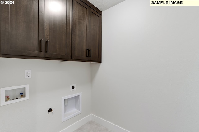 laundry room featuring cabinets, washer hookup, a textured ceiling, and hookup for an electric dryer