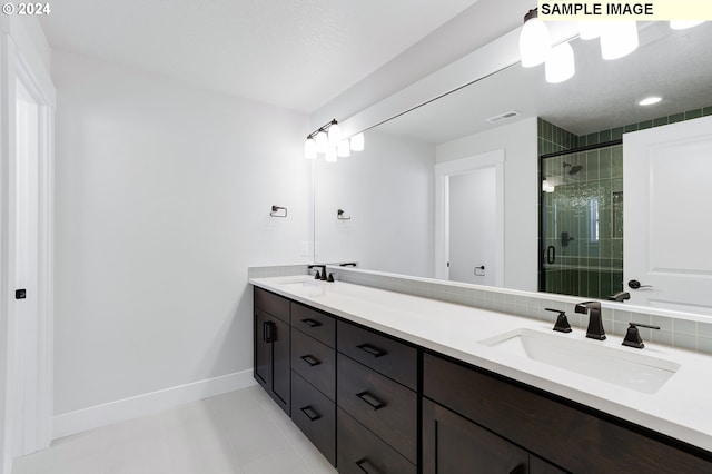 bathroom with tile patterned flooring, vanity, and a shower with shower door