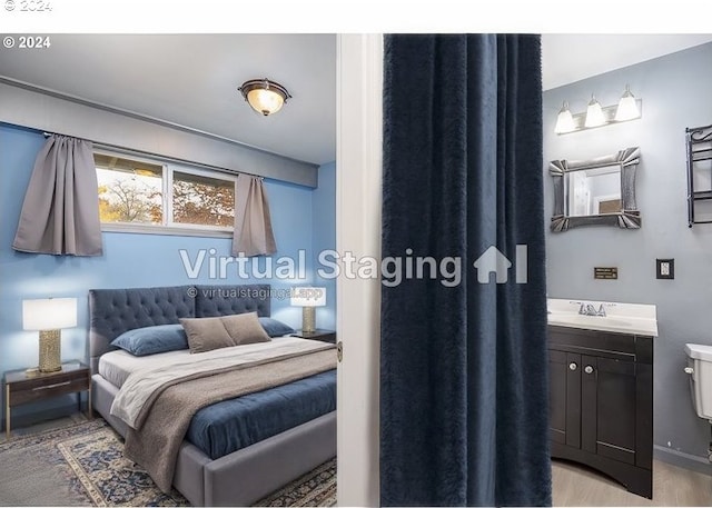 bedroom with light hardwood / wood-style flooring and sink